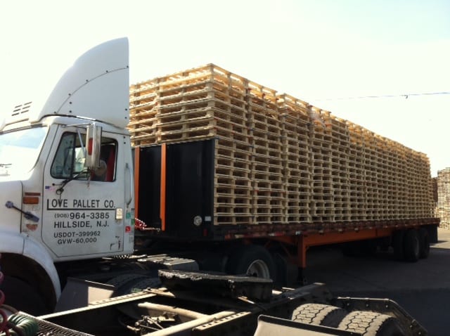 A truck with piles of pallets